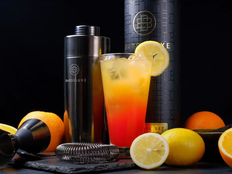 Close-up view of the Cocktail Tequila Sunrise in front of the black Bar Deluxe Cocktail-Set